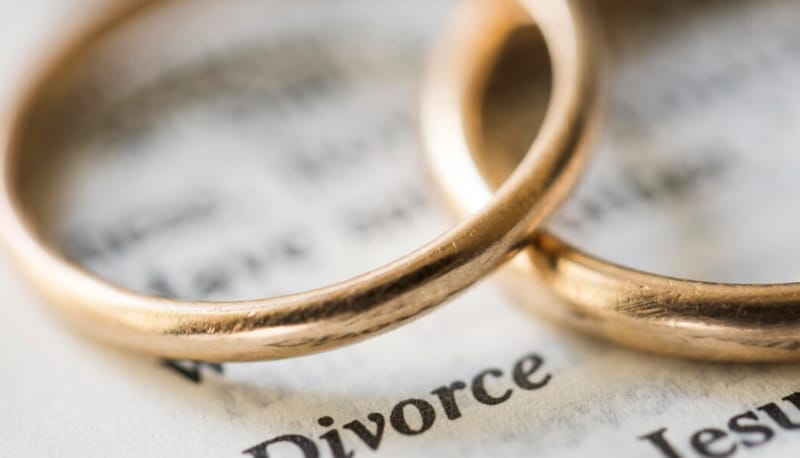2 rings placed above divorce paper