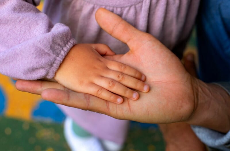 Father holding a child's hand