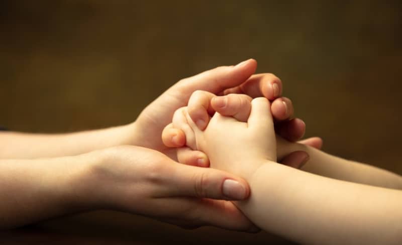 holding hands with child